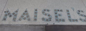 Maisel's in silver dollars on the sidewalk